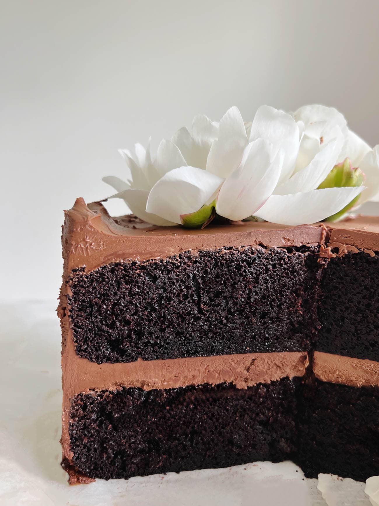 a chocolate cake with slice out of it looking at interior crumb