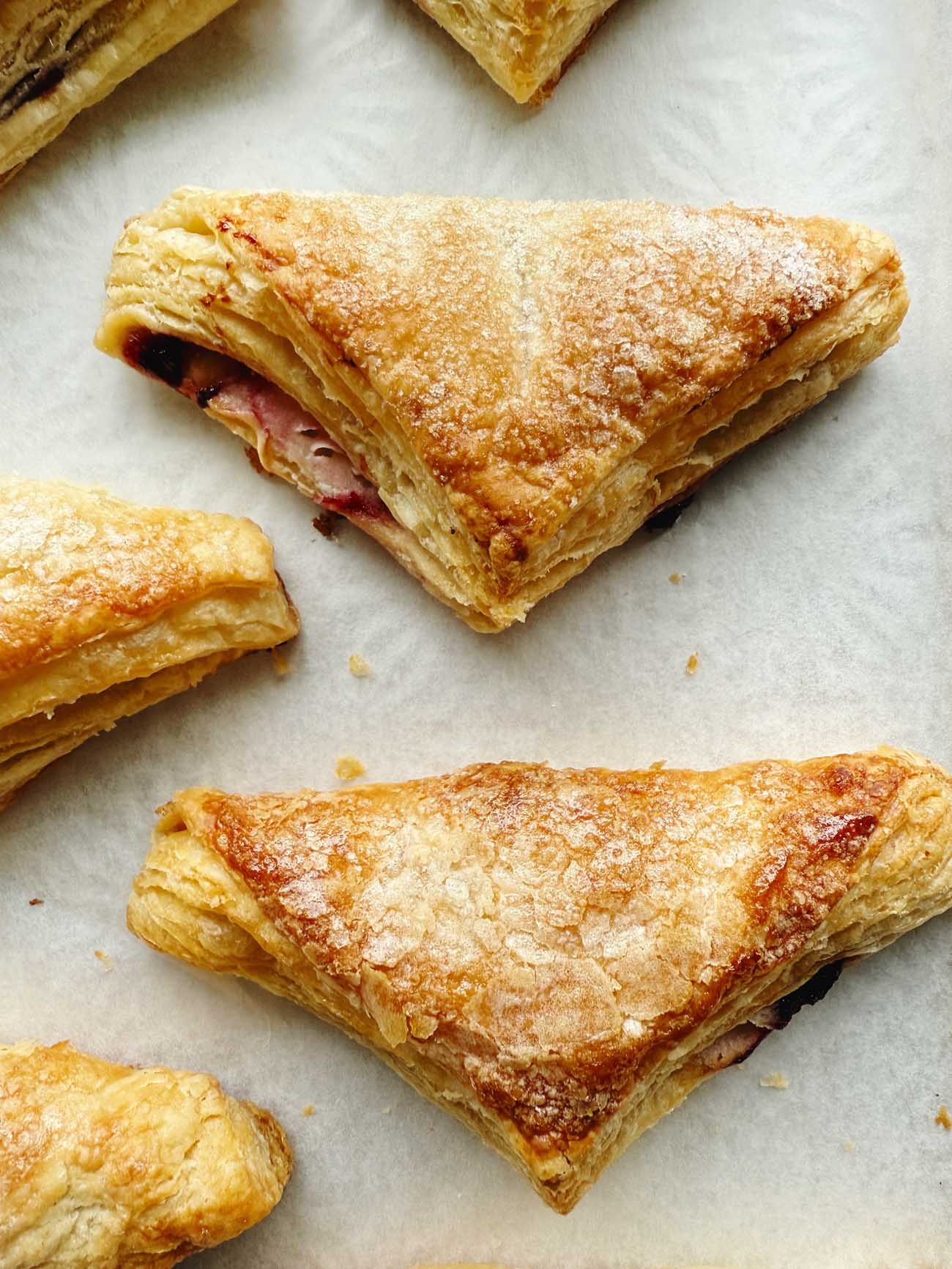 sour cherry turnovers on parchment paper