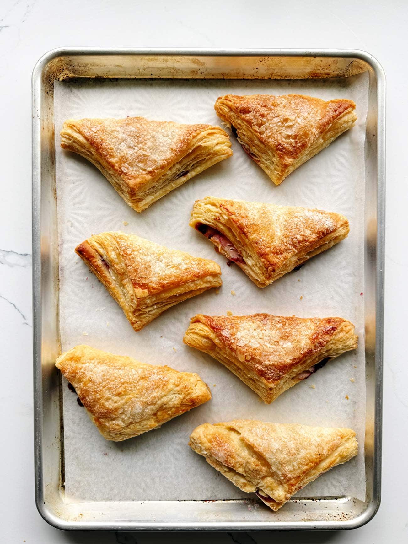 cherry turnovers on a baking sheet