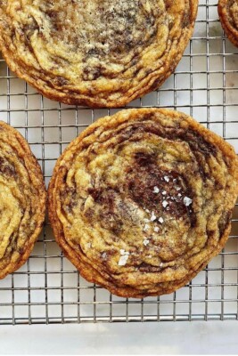 pan banging chocolate chip cookies on wire cooling rack
