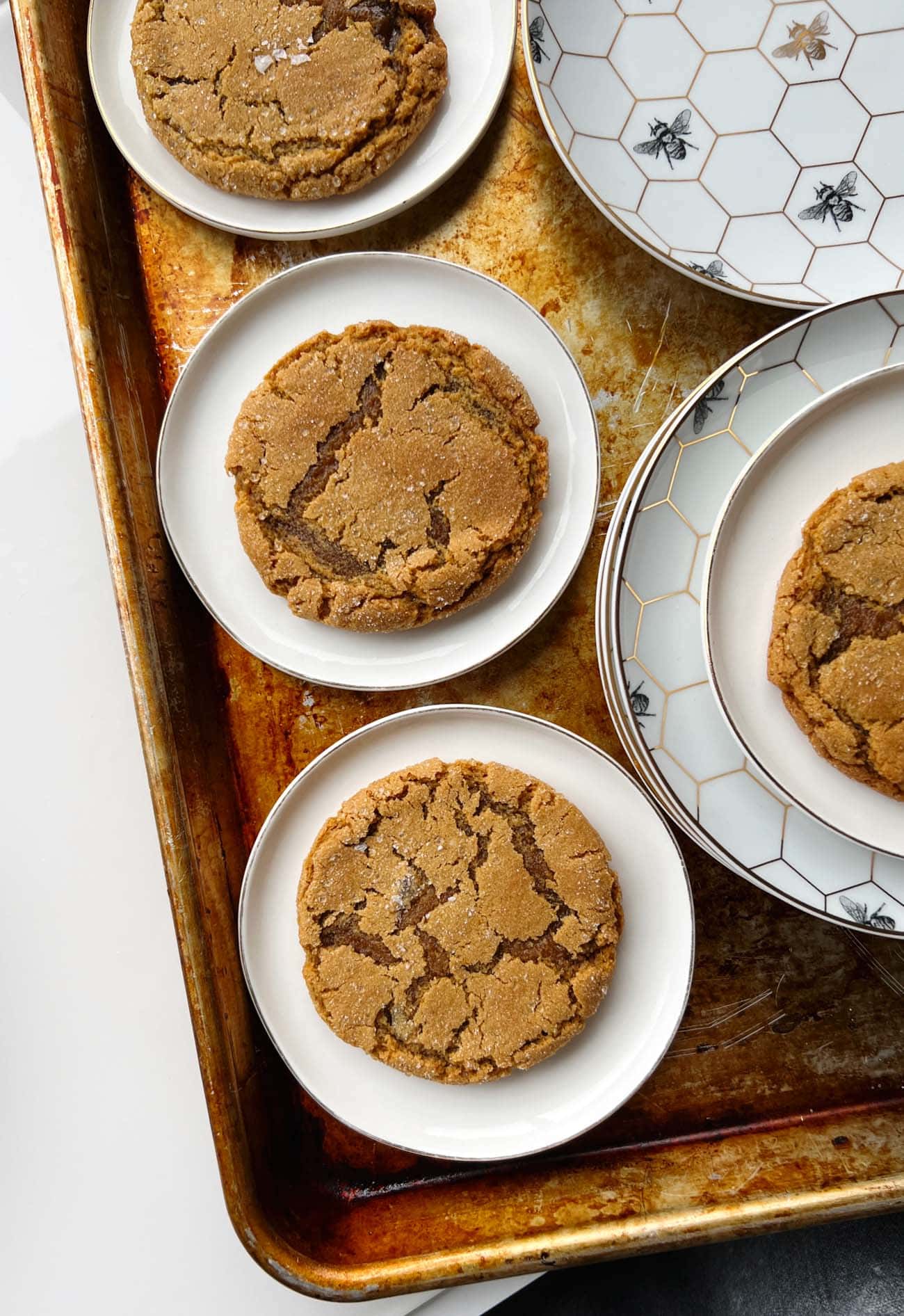 ginger molasses cookies on white and floral plates
