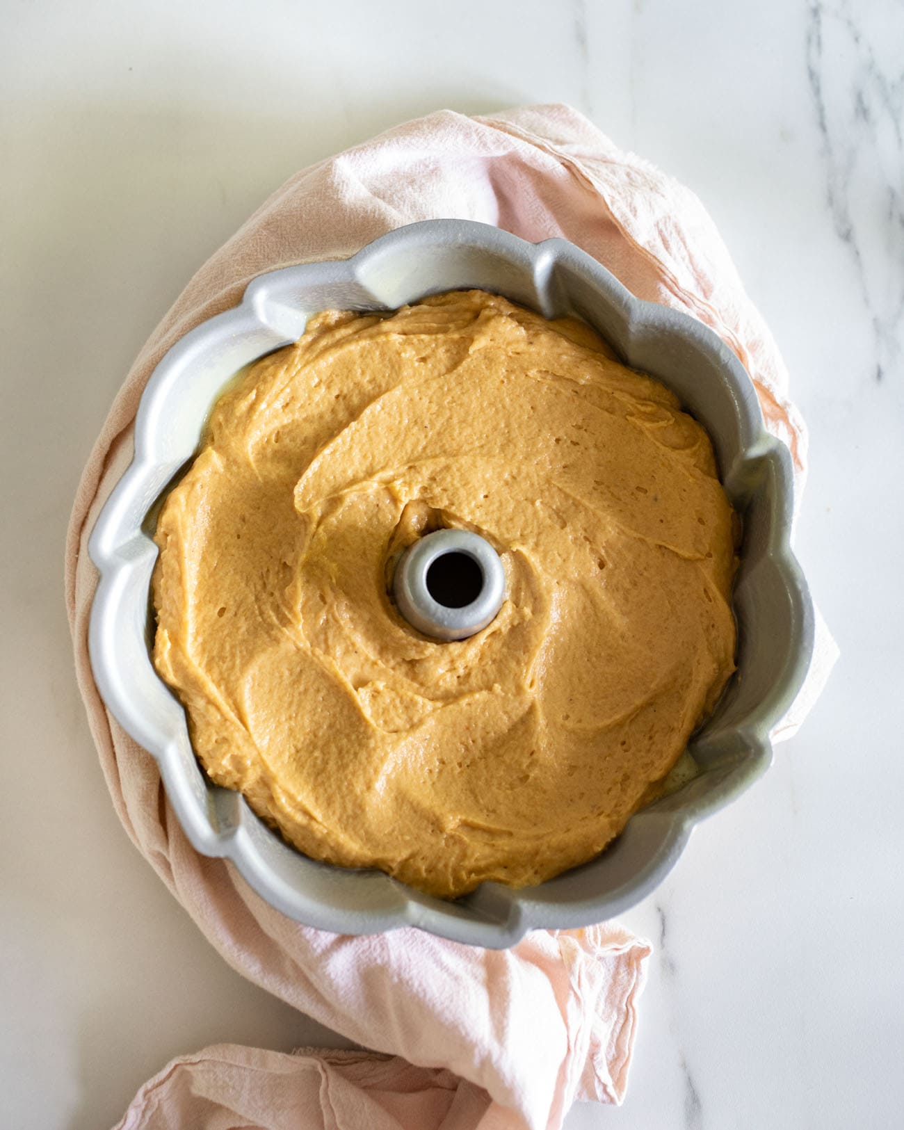 pumpkin cake batter in bundt pan