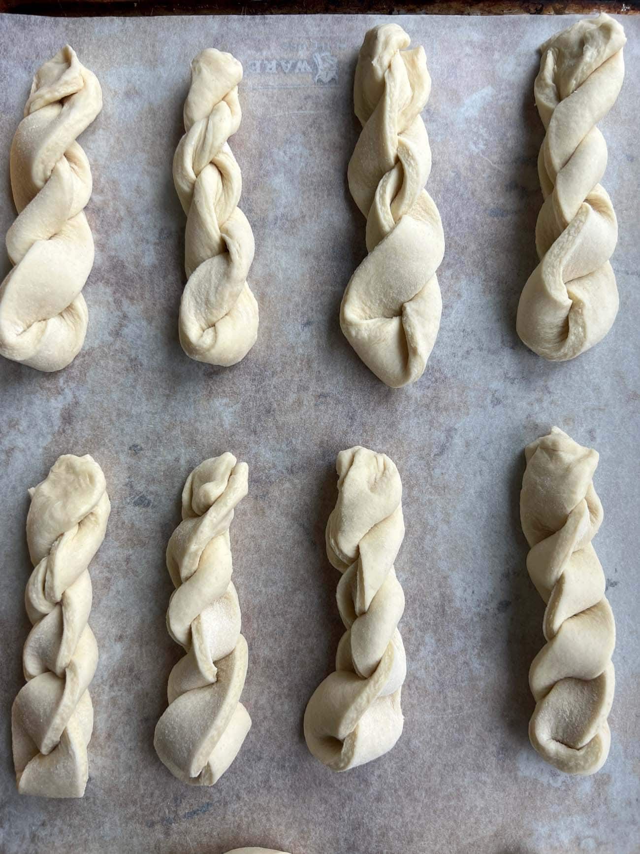 dough for croissant twists on baking sheet