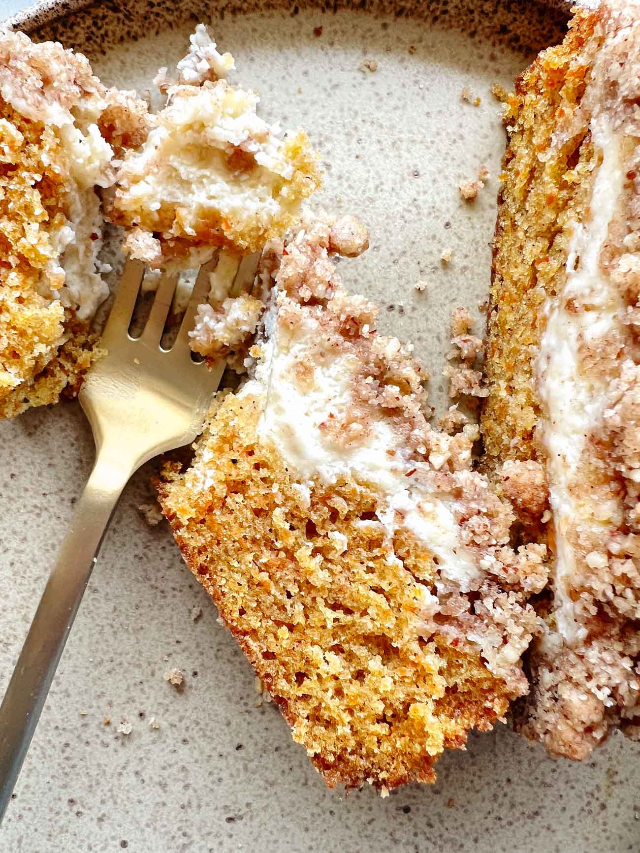 carrot cake coffee cake on a plate with gold fork