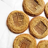 pan-banging peanut butter cookies on white surface