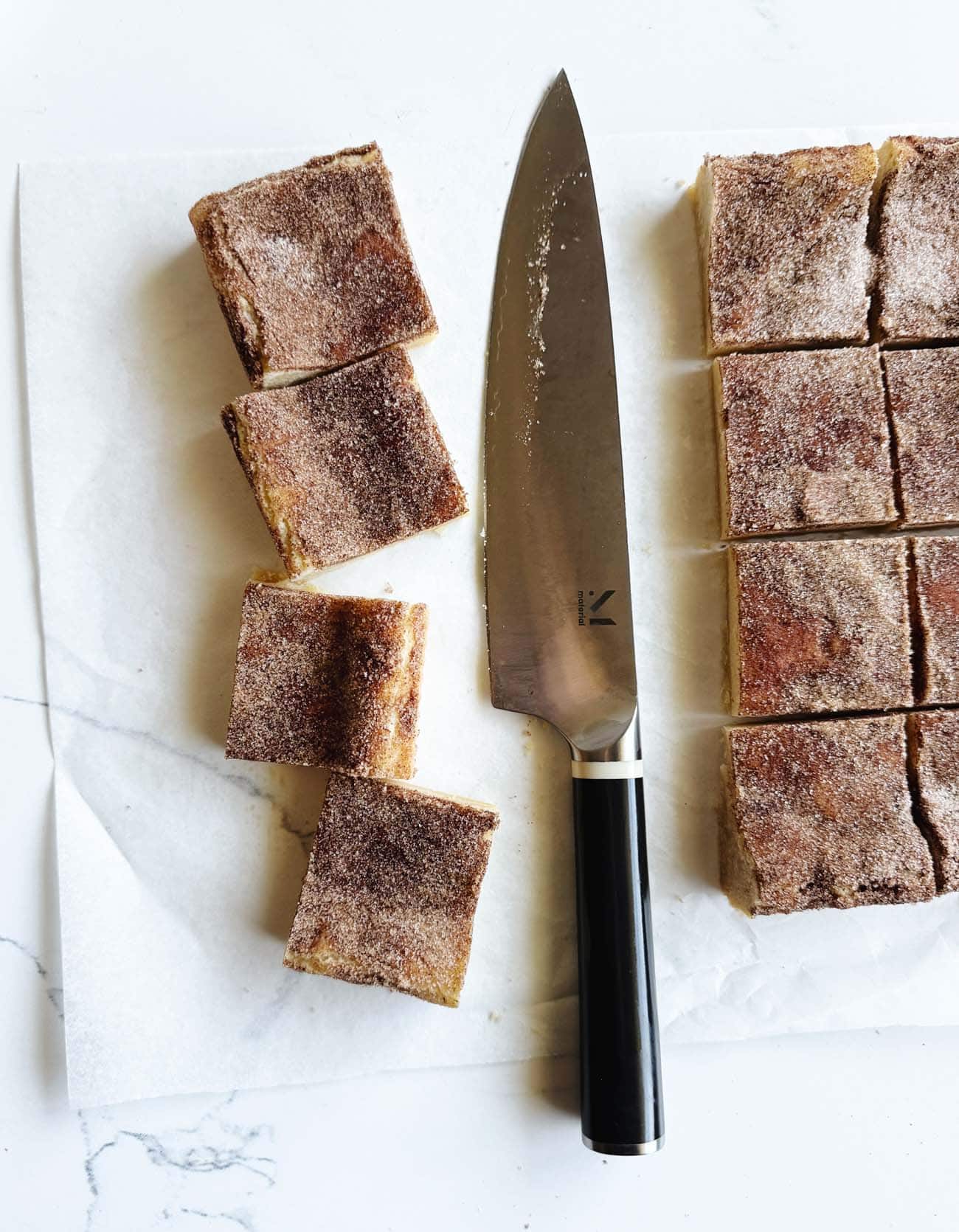 snickerdoodle bars on parchment, cut into squares